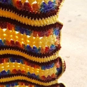 Homemade yellow blue and red crosstinc blanket in